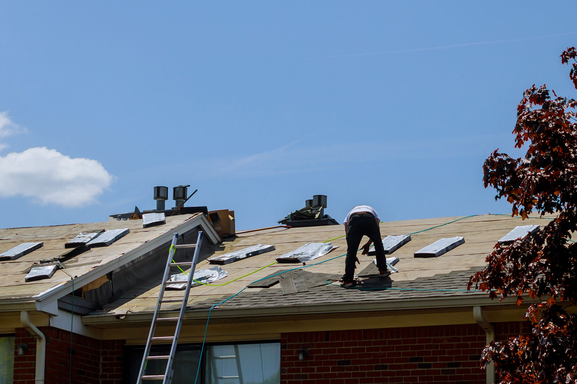 A man in a roof doing repairs.