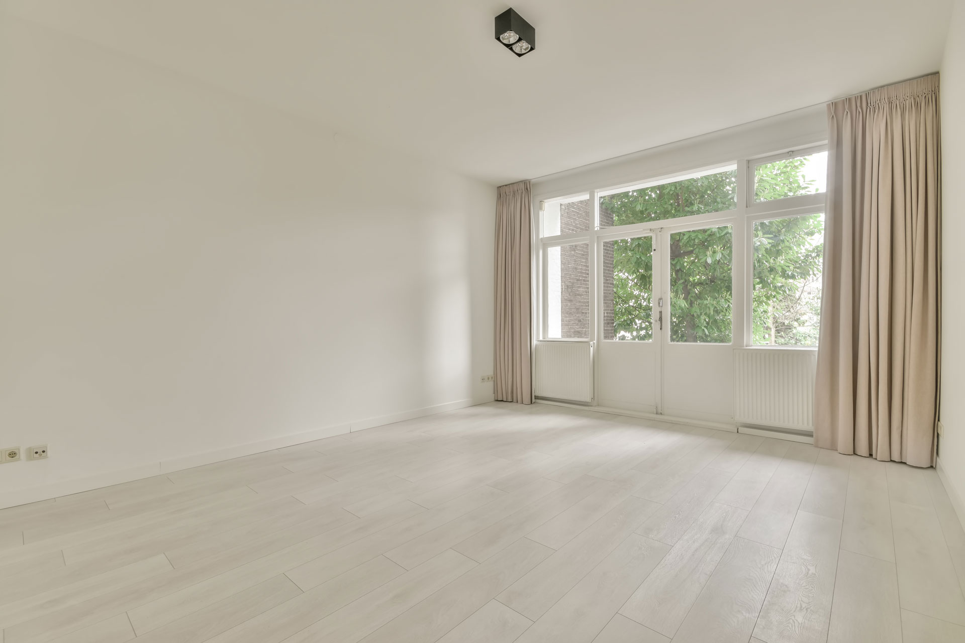 Spacious room with wide doors and windows