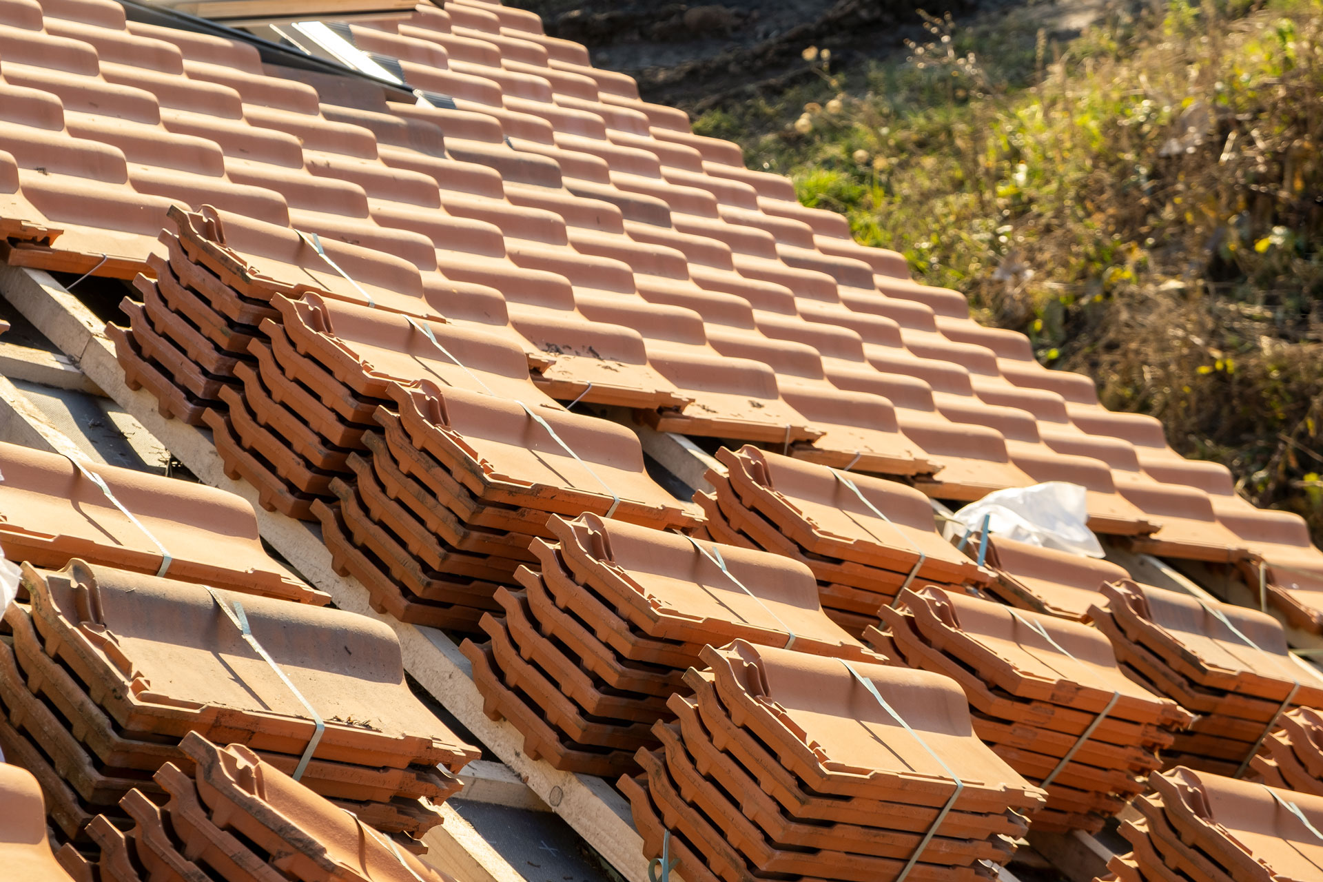 Stack of yellow ceramic roofing tiles.