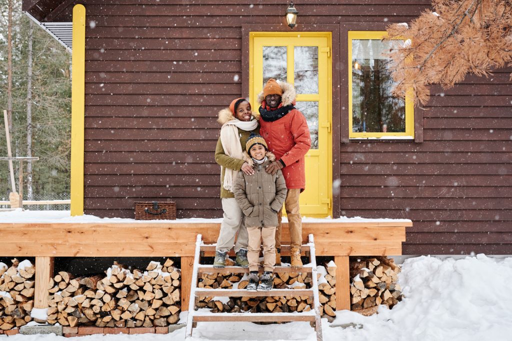 Family standing in front of their home.